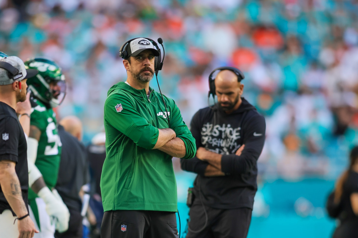 Dec 17, 2023; Miami Gardens, Florida, USA; New York Jets quarterback Aaron Rodgers (8) looks on from the sideline against the Miami Dolphins during the fourth quarter at Hard Rock Stadium.  